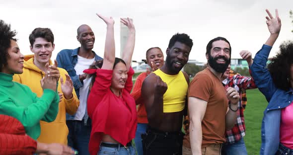 Happy multiethnic people dancing at city park