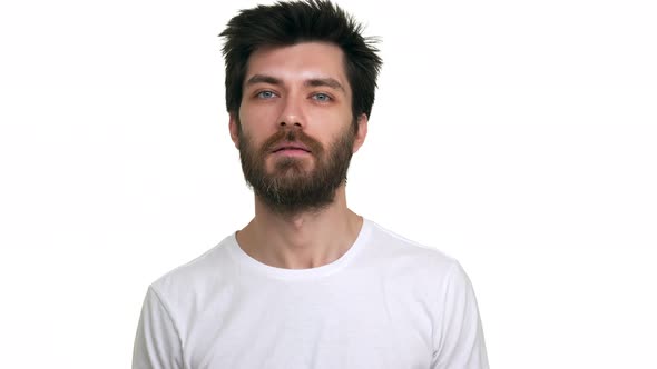 Young Relaxed Male Making Friendly Greeting Gestures on White Background