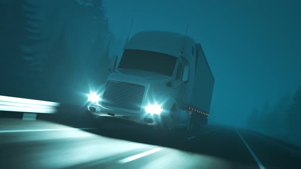 Semi truck with trailer driving through the forest during foggy night. Loop 4K