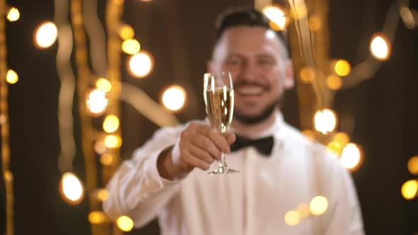 Portrait of Happy Man Raising Glass of Champagne