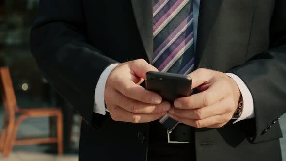 Male Reading Phone Message or Downloading an App for His Mobile Phone