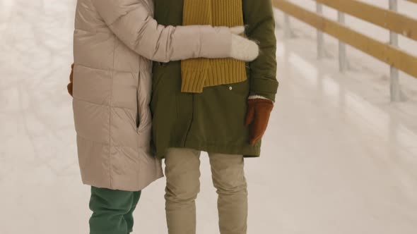 Mom And Daughter Hugging On Ice Rink