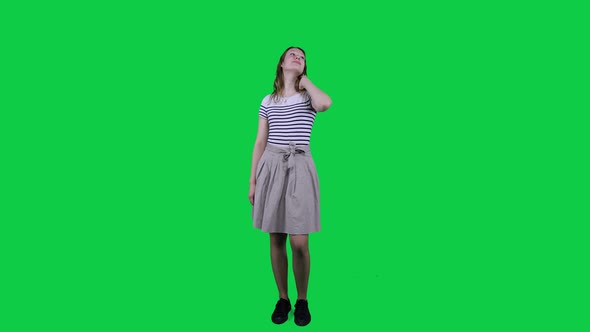 Teenage girl vibing to music in front of a green screen