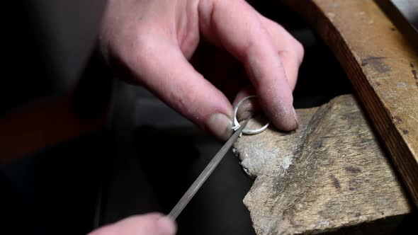 Closeup of Wedding Ring Polishing By Caicasian Jeweler Isolated  Footage