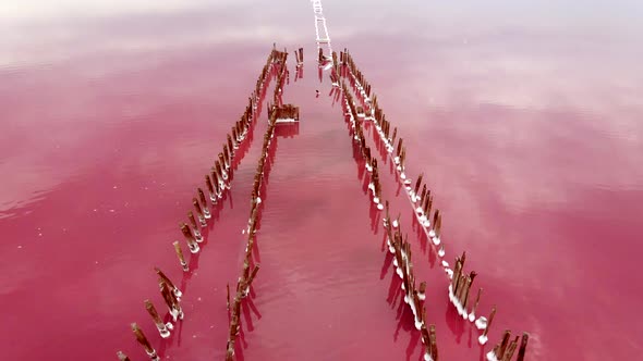 Abandoned Pier on Pink Lake Medicinal Clay Ungraded on Sunset, Air Drone View