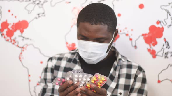 American Man in a Well-used Mask Chooses Antiviral Drug for Self-medication