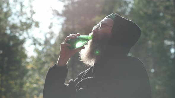 The Bearded Man Drinks Mineral Water