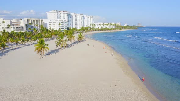 Tropical Playa Hemingway with palms next to azure blue Caribbean; aerial