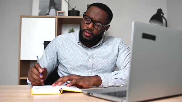 An African Guy Is Using Laptop for Work