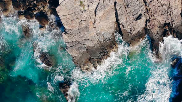 Top View of Coastal Rocks Getting Washed By the Ocean