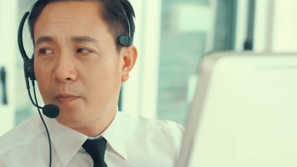 Businessman Wearing Headset Working Actively in Office