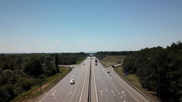 Fly Over Highway Road Junction in the Countryside with Trees and Cultivated Fields