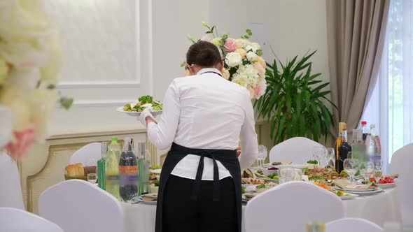 Girl Waiter Sets the Table