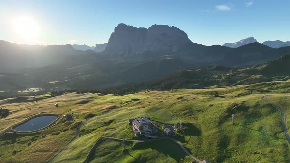 Dolomites mountains peaks with a hiking path on a summer sunrise