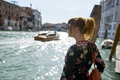 Caucasian redhead woman with floral dress looking at grand canal Venice - PhotoDune Item for Sale