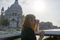 Redhead girl with long black dress, sunglasses and cowboy boots standing on yacht in Venice - PhotoDune Item for Sale
