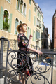 Caucasian redhead woman with floral dress standing on a bridge in a canal in Venice - PhotoDune Item for Sale