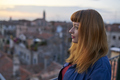 Caucasian redhead woman with denim dress overlooking rooftops in Venice - PhotoDune Item for Sale