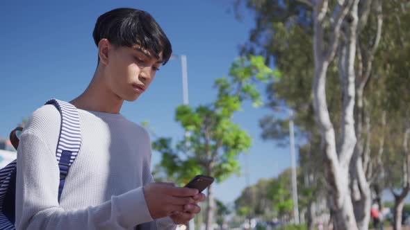 Transgender adult using a phone in the street