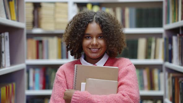 African American Girl Smiling in Library