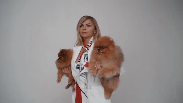 Fashionable Girl with Scarf Holding a Chihuahua Dog in Her Arms