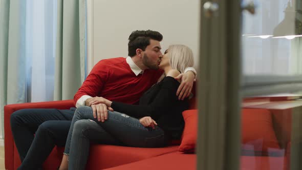 Couple relaxing on a couch and kissing