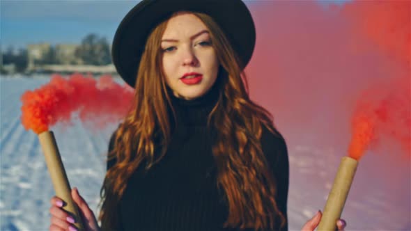 Beautiful Woman Holding Colored Smoke in Sunlight