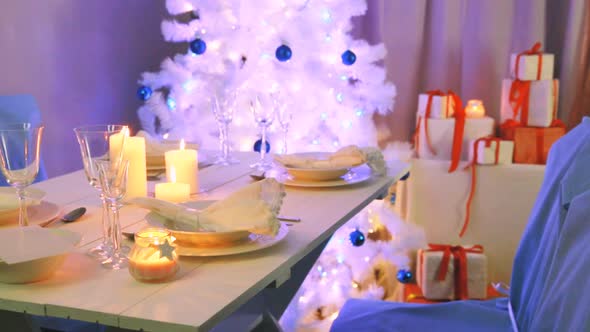 Beautifully decorated white table for Christmas Eve