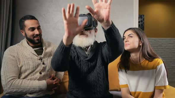 Elderly Man Enjoys Virtual Headset with Children