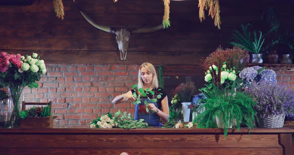 Florist Wraps a Bouquet in a Flower Shop