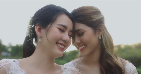 Asian Lesbian Married Couple Enjoying Romantic Moments Outside, Slow Motion.