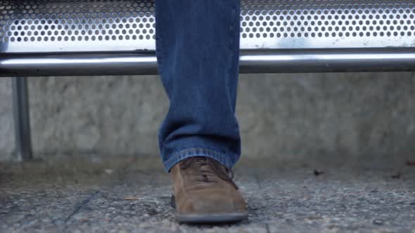 the man waiting with a leather suitcase