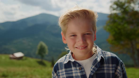 Portrait Happy Boy Looking Camera on Mountains