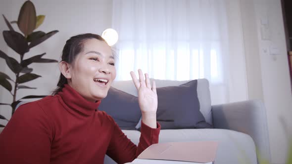 Businesswoman on redshirt using the laptop for meeting online and work from home