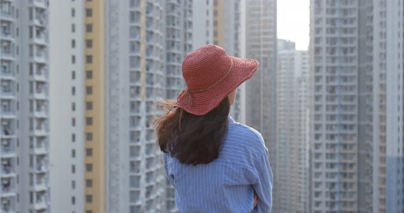 Woman Look at The Apartment Building in City