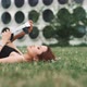A woman lying on the grass while trying virtual reality glasses - VideoHive Item for Sale