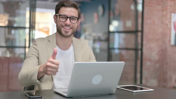 Thumbs Up By Young Man with Laptop