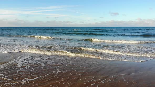 Aerial view of the North Sea rolling waves outside Løkken, Denmark