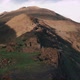 Amazing aerial view of abandoned village, drone flies between stony buildings, mountain summit back - VideoHive Item for Sale