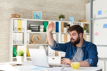 ing with partner by video call at desk in office