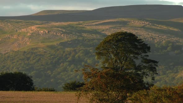 Panning shot of the North Pennines in Cumbria highlighted by the evening light.