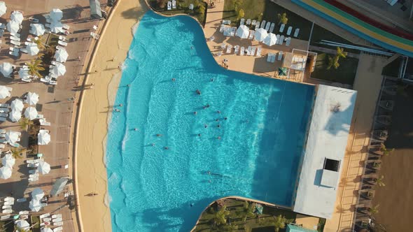 People Swim At Blue Swimming Pool Of Aquafan Aventura At Costa Park In Tigre, Buenos Aires, Argentin