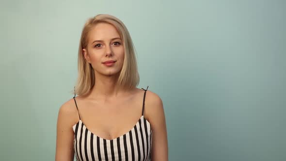 Smiling woman in dress on blue background