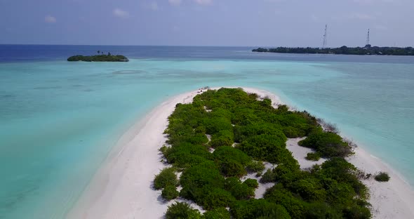 Daytime overhead abstract shot of a white sandy paradise beach and aqua blue ocean background in col