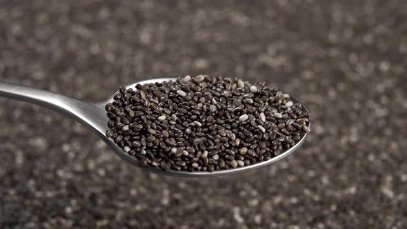 Full metal spoon of chia seeds close-up