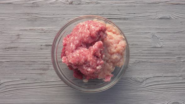 Top View of the Male Hands Mixing Various Kinds of the Raw Minced Meat