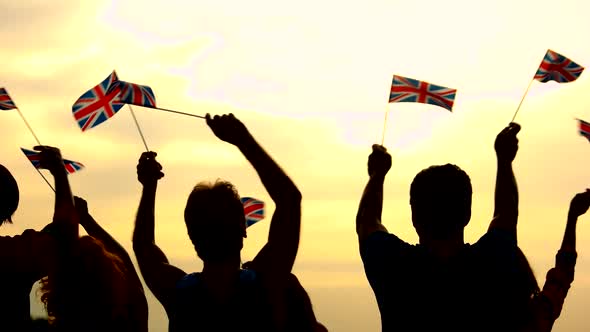 People Raising British National Flags