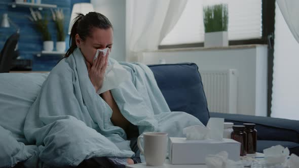 Sick Woman Using Tissue to Blow Runny Nose Having Cold