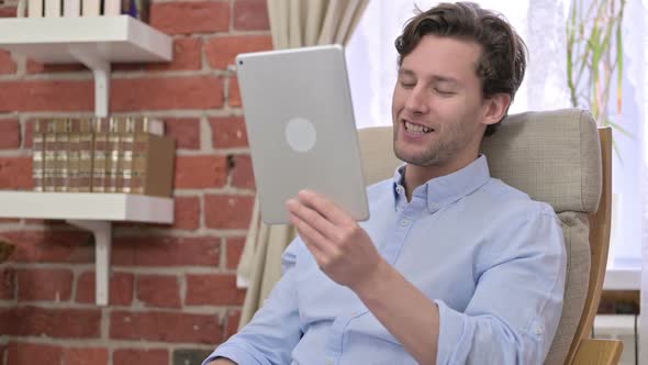 Ambitious Young Man Doing Video Chat on Tablet