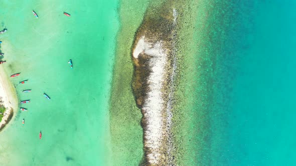 Wide flying copy space shot of a white sand paradise beach and turquoise sea background in colourful